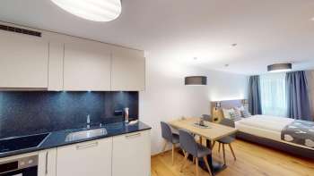 Ferienwohnung 12 Küchenzeile, Esstisch und Doppelbett