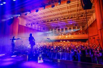 Konzert von Silbermond beim FL1.Life Festival im SAL in Schaan mit begeistertem Publikum und stimmungsvoller Bühnenbeleuchtung