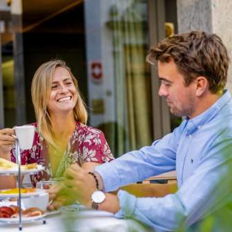 Ein Paar geniesst ein Frühstück im Freien auf einer Terrasse in Vaduz, umgeben von entspannter Atmosphäre