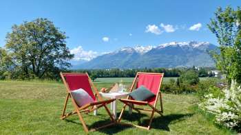 Liegestühle im Garten der Herzli-Suite mit den Alpen im Hintergrund