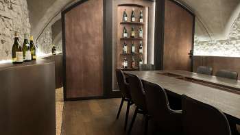 Eleganter Degustationsraum der WY Weinbar mit Gewölbedecke und edlem Holztisch für exklusive Weinverkostungen.