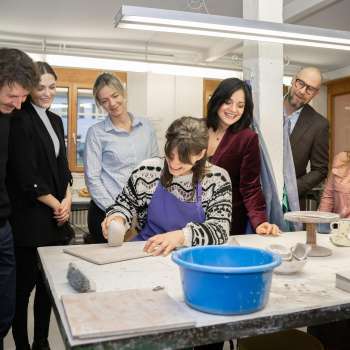 Eine Gruppe interessierter Besucher beobachtet eine Töpferin beim Modellieren – Kreativerlebnis in gemütlicher Atmosphäre in der Keramikwerkstatt Schädler in Nendeln.