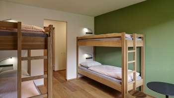 Vierbettzimmer mit Etagenbetten und Holzboden in der Jugendherberge Schaan/Vaduz